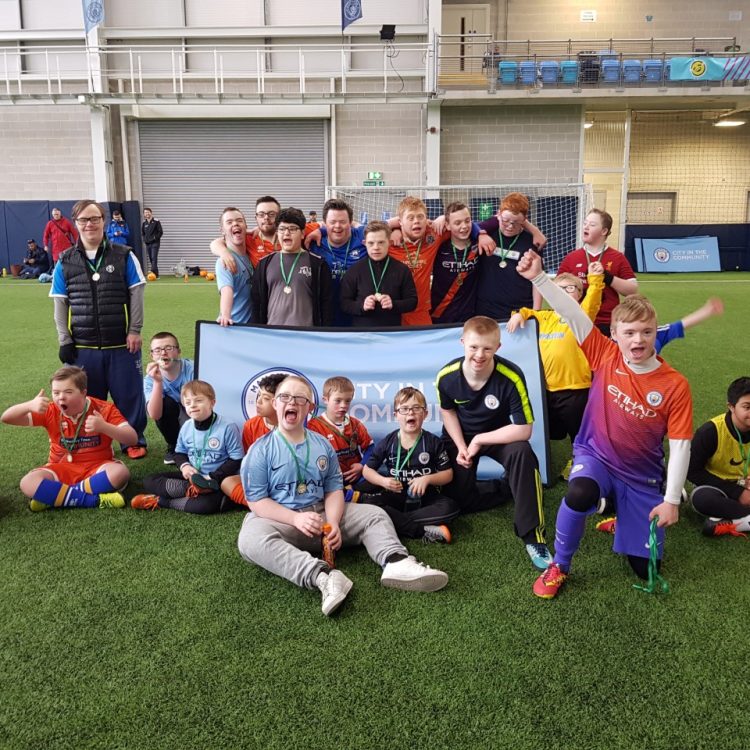 Group Photo of Down Syndrome Participants at Man City
